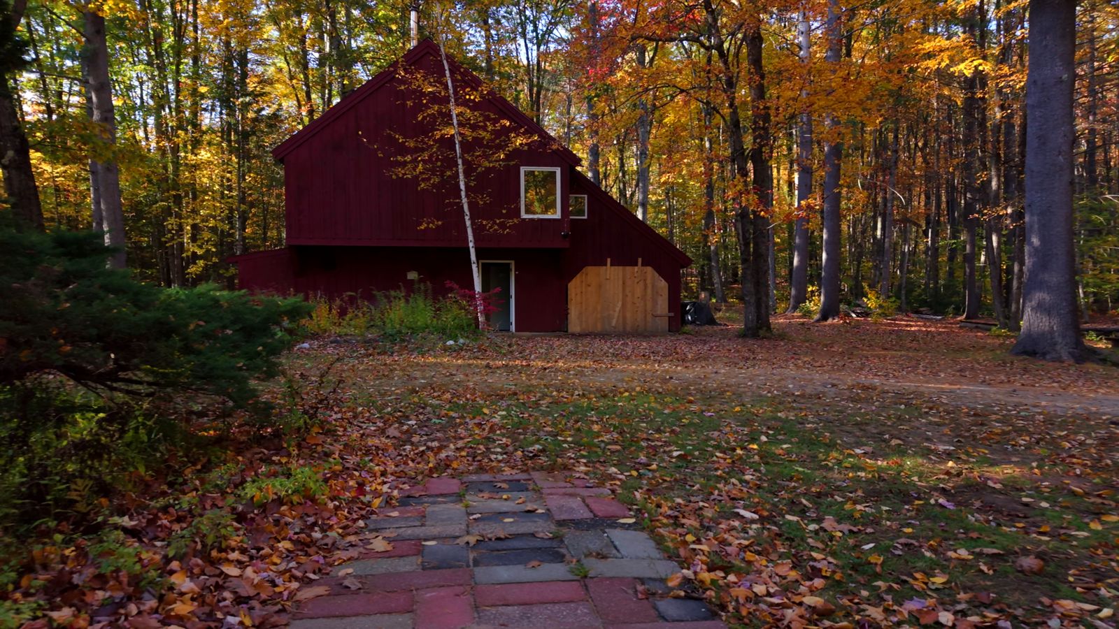 The red guest house surrounded by peak fall foliage